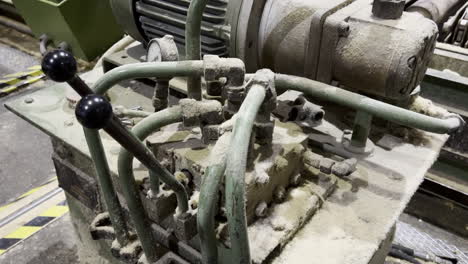 Close-up-shot-of-an-old-vintage-machine-covered-with-dust-in-an-old-factory
