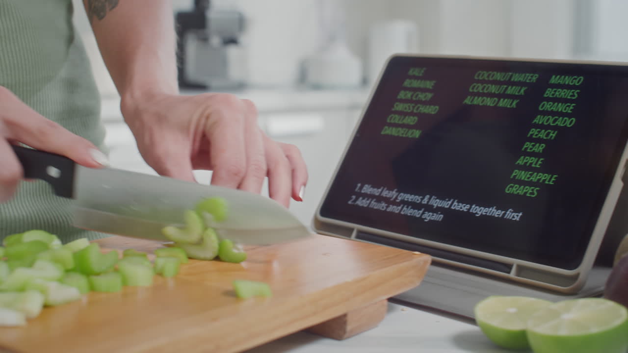 Woman Cooking Salad Using Recipe on Tablet