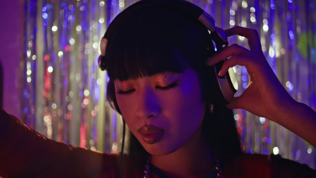 Relaxed DJ headphones dancing fine-tuning music at trendy nightclub closeup