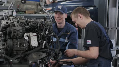 car engine repair by mechanics in a workshop