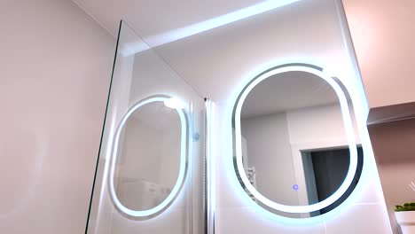 modern illuminated mirror in a small, practical bathroom, real estate