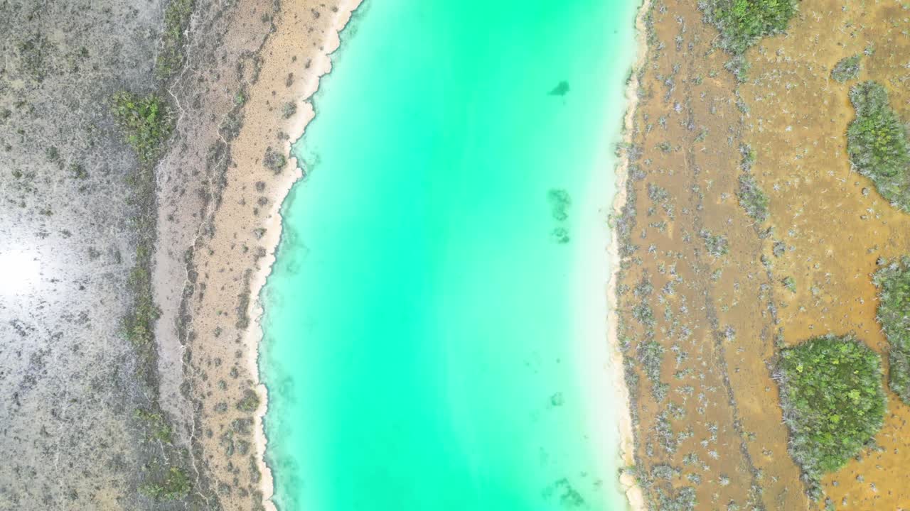 Aerial view of turquoise lagoon shoreline in Bacalar, Mexico, nature's beauty