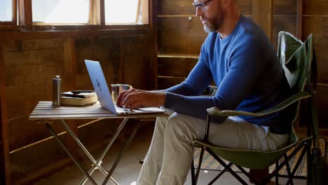 man using laptop at home 4k