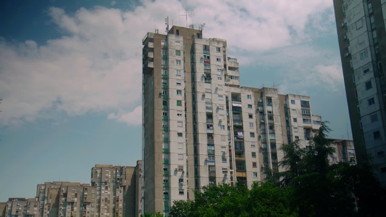 High-rise apartment building in New Belgrade, showcasing urban residential architecture against partly cloudy sky. Tall structures emphasize city's modernist design in dense setting.New Belgrade