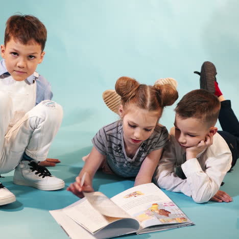 funny children read a book on decorative background. studio shooting of children square video