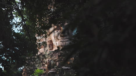 buddha face of bayon reveal from jungle