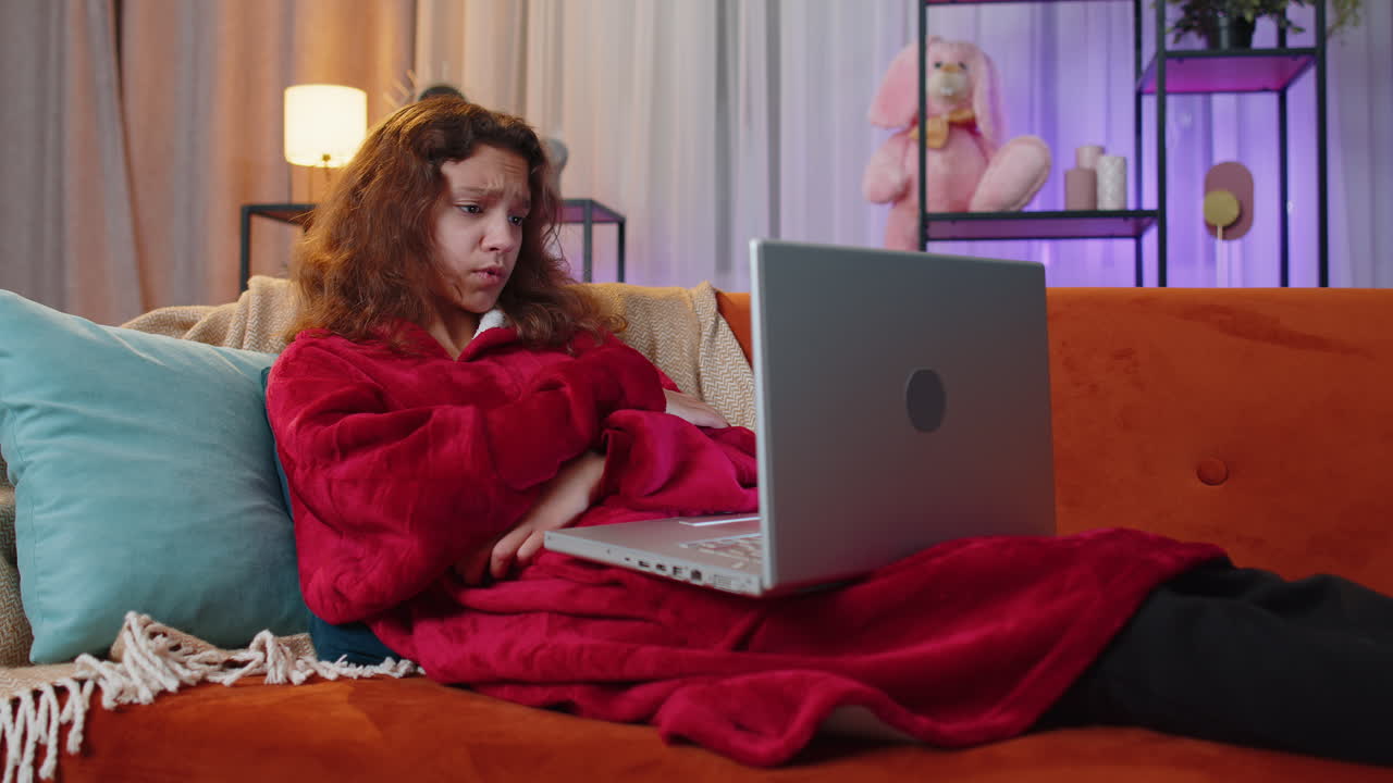 Preteen teenager girl use laptop surprised by bad news fortune loss fail lottery results at home