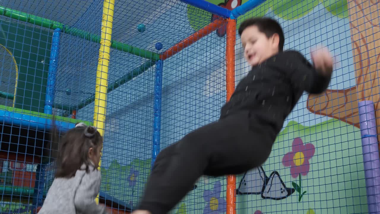 Children jump on trampolines in the children's entertainment center. Trampoline entertaining game center. Playroom
