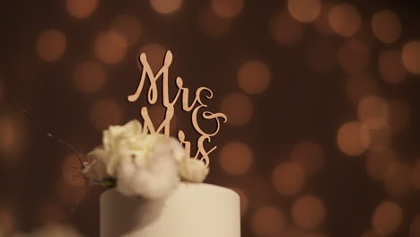 mr - mrs cake topper on white cake, bokeh background