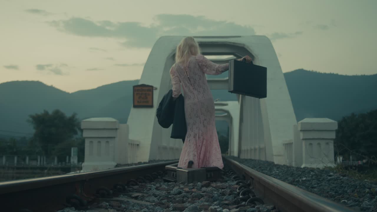 Woman Walking Away on a Bridge