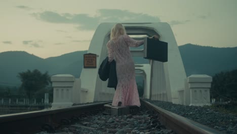 woman walking away on a bridge