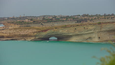 Timelapse-of-Hofriet-Window-rock-arch-on-coastline,-Malta