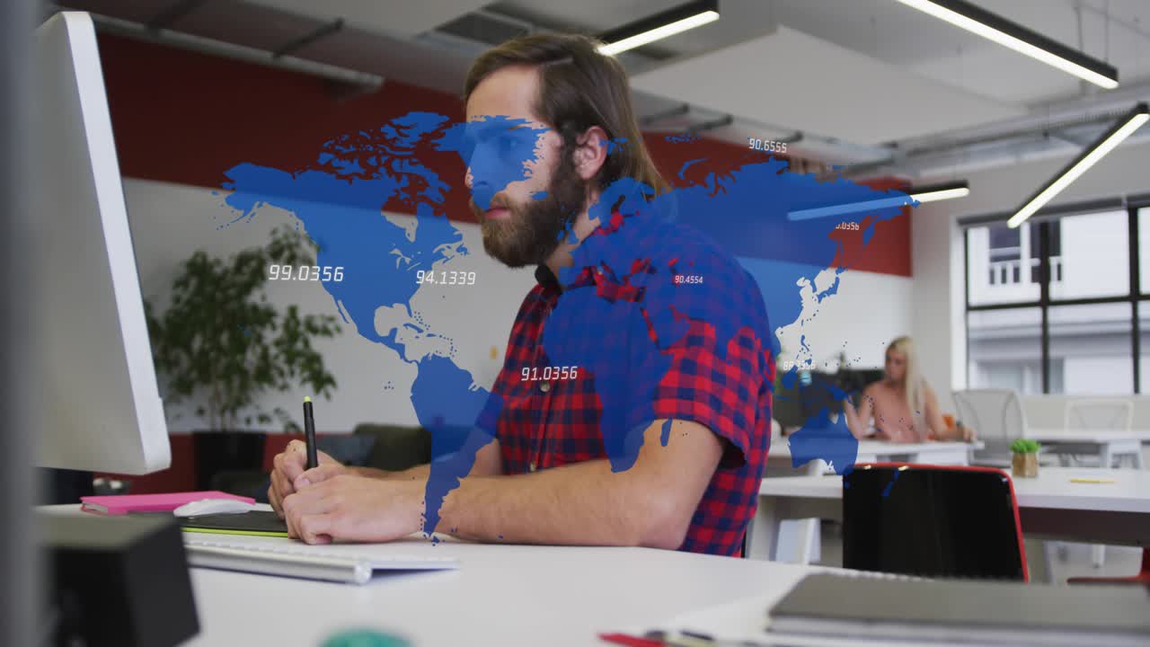 Man making notes at desk, stylus tapping tablet while blue map overlay annotating data analytics