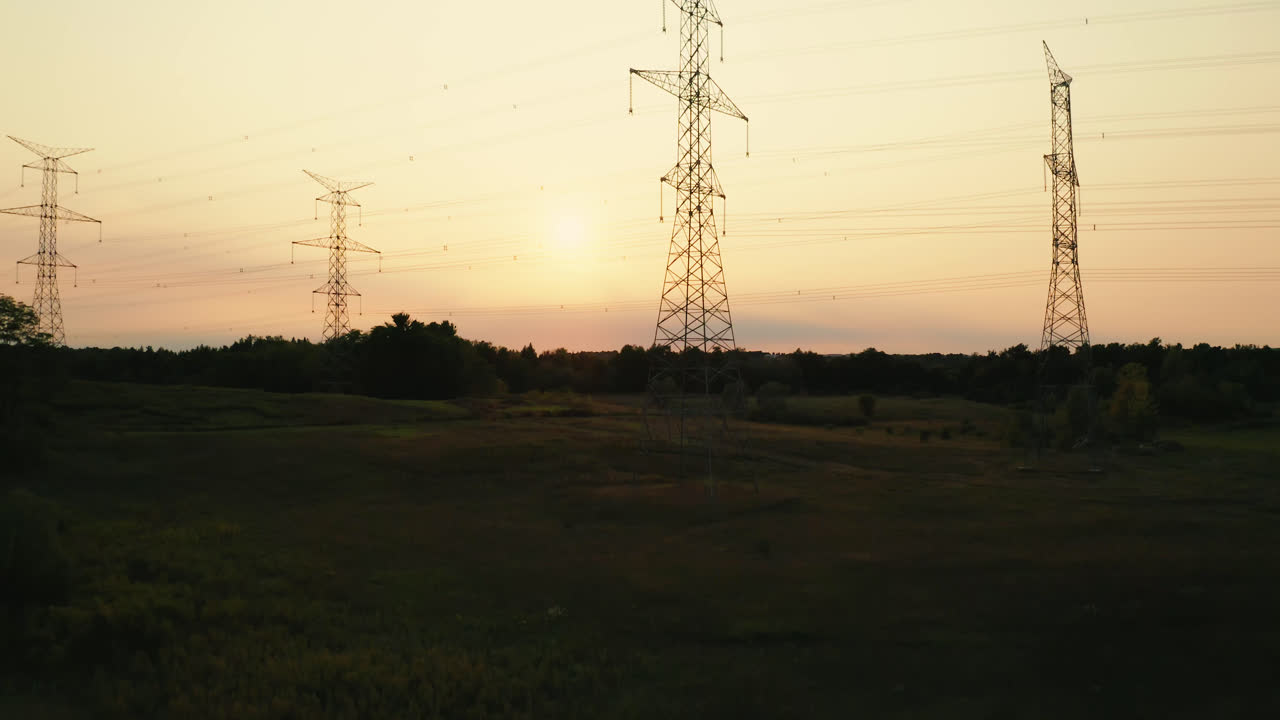 Aerial Flyover of High Voltage Transmission Power Lines Silhouette in Rural Countryside