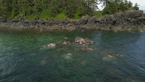 Rocks-Surfacing-in-a-Shallow-Pool-of-Water-Along-the-Coastal-Area-of-Moresby-Island,-Canada