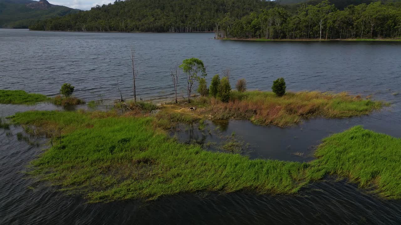 Circular aerial views of a small island on Advancetown Lake near the Western Boat Ramp on the Gold Coast Hinterland.