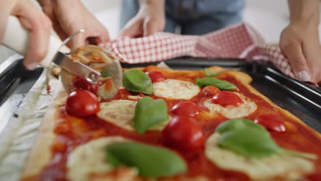 Tracking-video-of-slicing-homemade-pizza-on-the-table