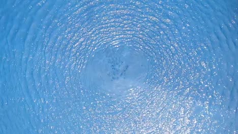 aerial view of blue pool water rippling in slow motion