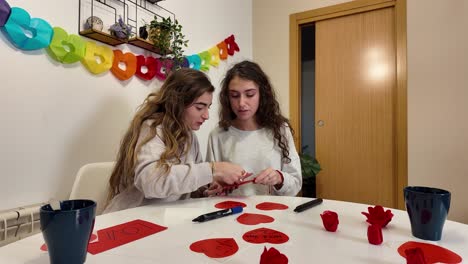two friends making valentine's day crafts