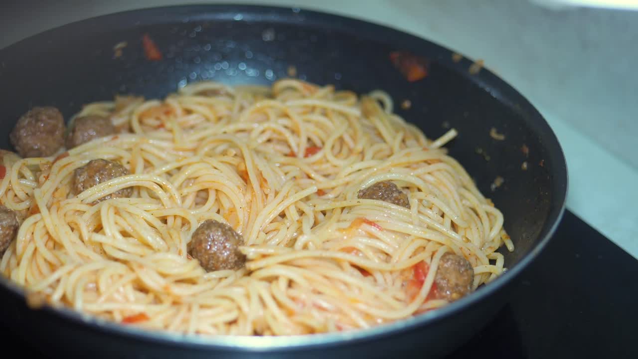 Spaghetti with Meatballs Cooking in a Pan
