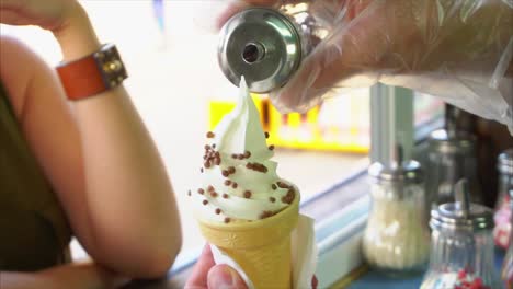 persona que sostiene un cono de helado