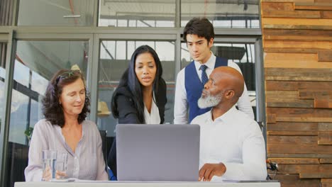 Executives-discussing-over-laptop-in-the-office-4k