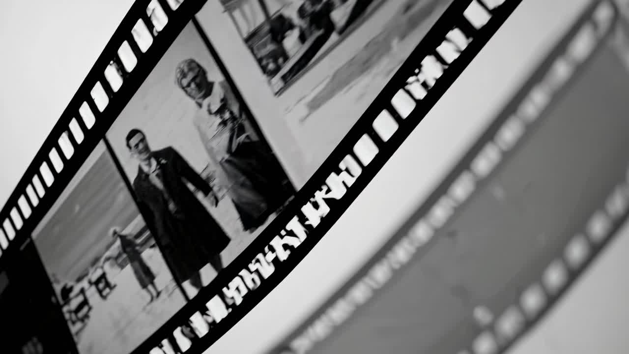 Close-up of black and white film strips, angled diagonally, capturing a vintage video aesthetic