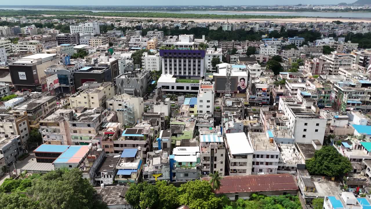 A sweeping aerial view of Vijayawada, showing both its urban vibrancy and the serene hill in the background.