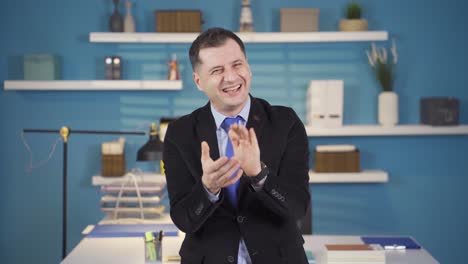 Businessman-clapping-and-happily-looking-at-camera.