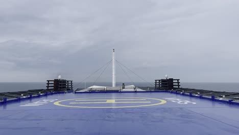 helicopter landing pad on a ship with the ocean in the background