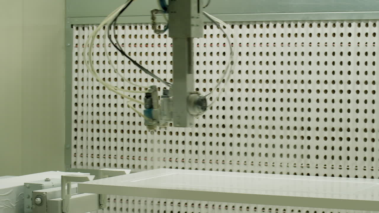 Automated sprayer in manufacture. Modern equipment for door production in the workshop. Industrial device working inside the plant.