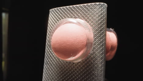 Curved-blister-with-pink-pills-under-transparent-shell