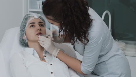 woman receiving lip injection in a beauty clinic