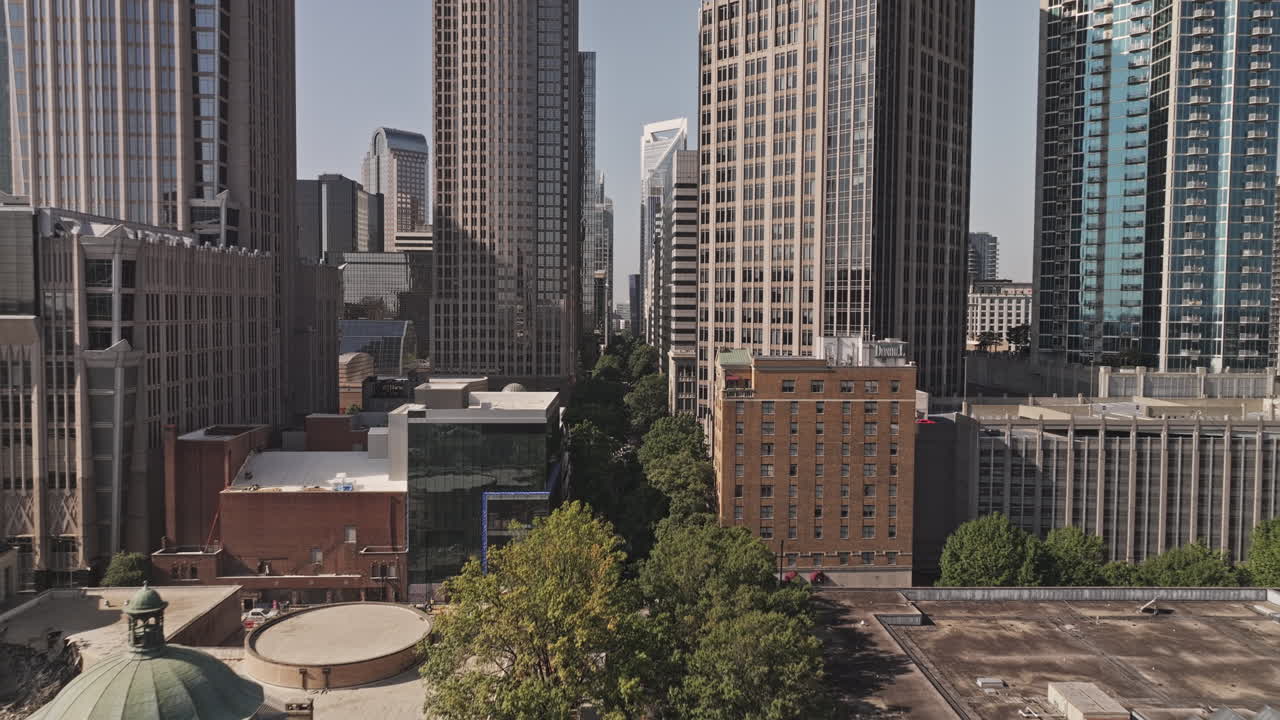 Charlotte North Carolina Aerial v179 low flyover Tryon street capturing vibrant downtown cityscape, lined with leafy trees and towering skyscrapers - Shot with Mavic 3 Pro Cine - Oct 2st 2023
