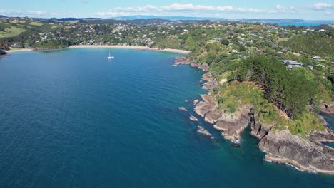 distant view of palm beach on mawhitipana bay, waiheke island, new zealand