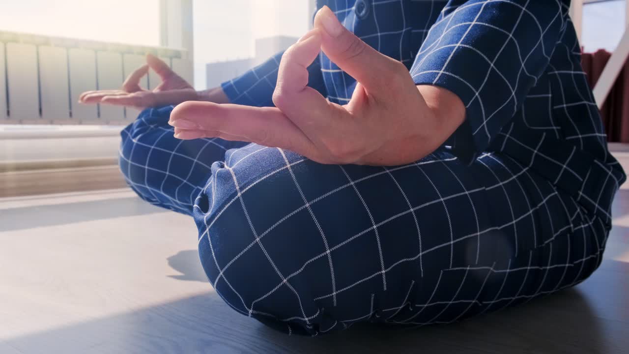 A Serene Moment of Mindfulness: Meditation Practice in a Modern Setting with Natural Light Streaming Through Large Windows