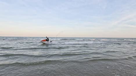 sailboat traversing the horizon on gentle waves