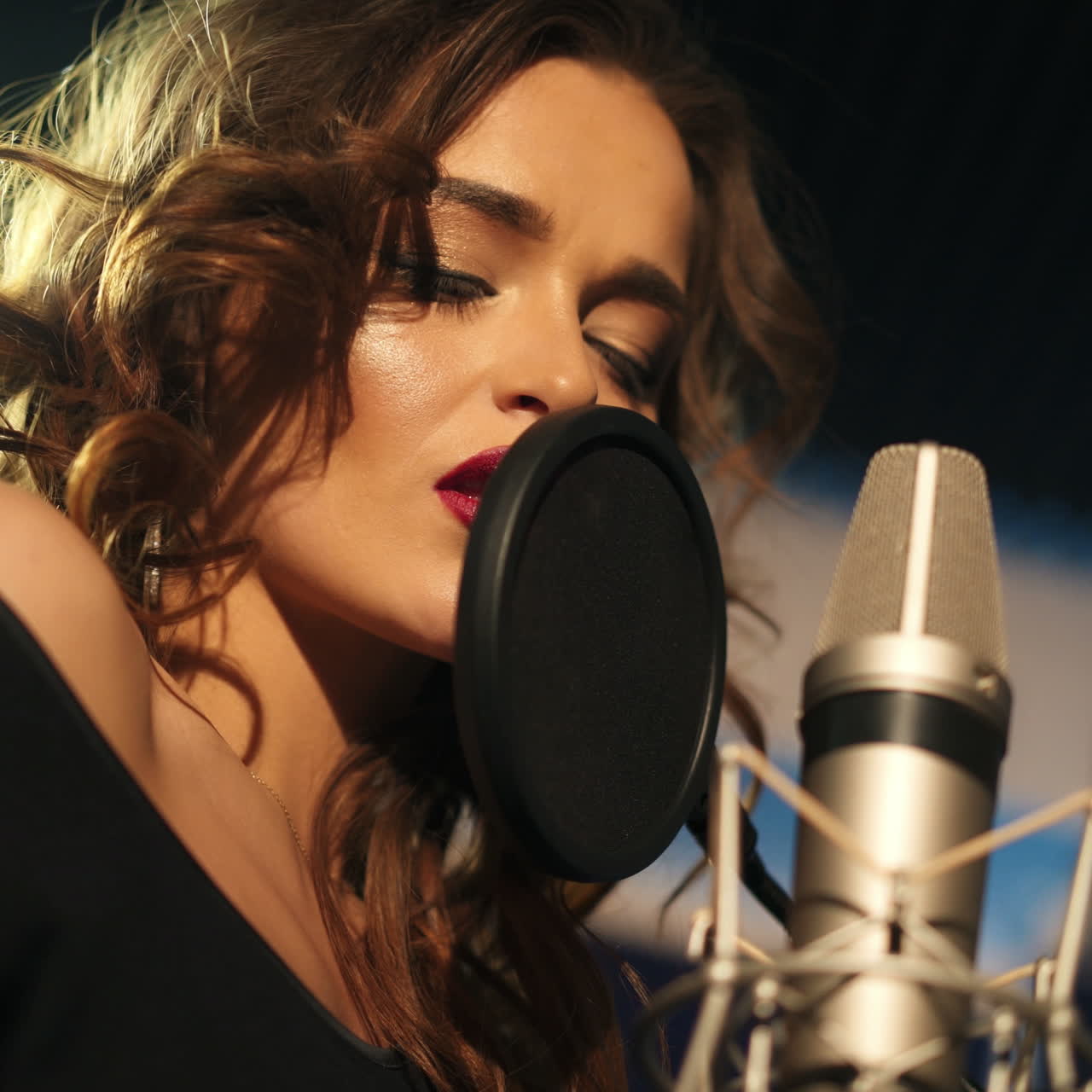Beautiful young singer who recorded a song in a professional recording studio. Female singer Square video