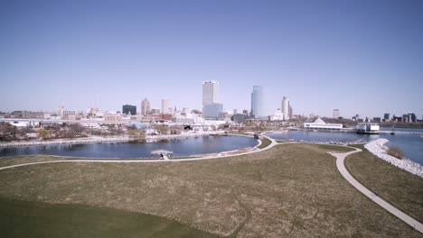 south west aerial side motion view of daytime milwaukee city skyline and skyscrapers