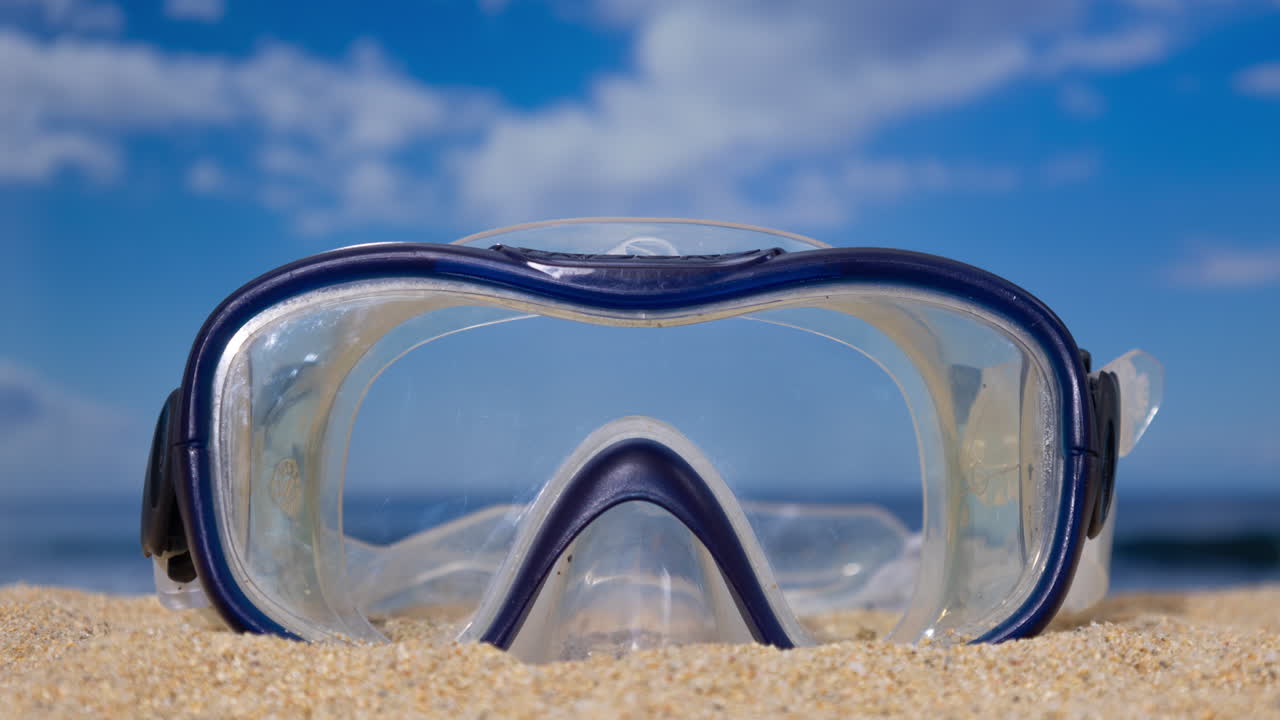 A snorkel mask on the beach