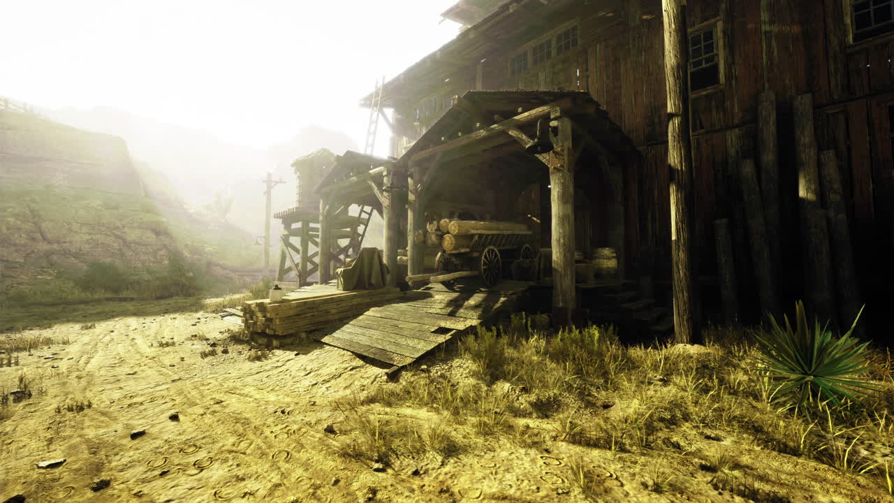 Abandoned wooden structure in dusty landscape during early morning light