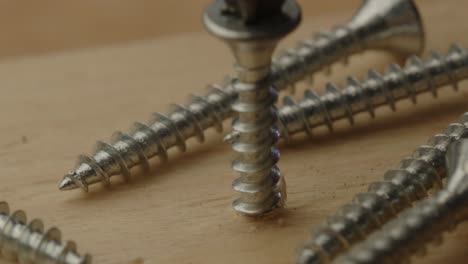 macro close up of metal screw drilled into wooden beam