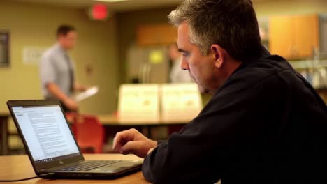 man working on laptop in office