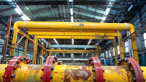 a large yellow pipe in a large industrial building