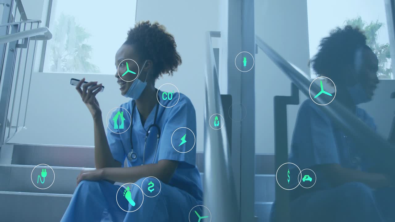 Female nurse on stairs speaking into smartphone and generating icons visualizing health tech data