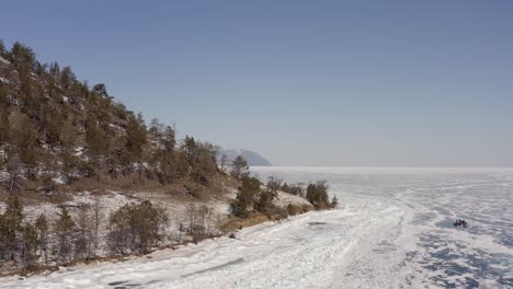 a circular flight around a group of tourists sitting on vacation after a long skiing on the ice lake baikal