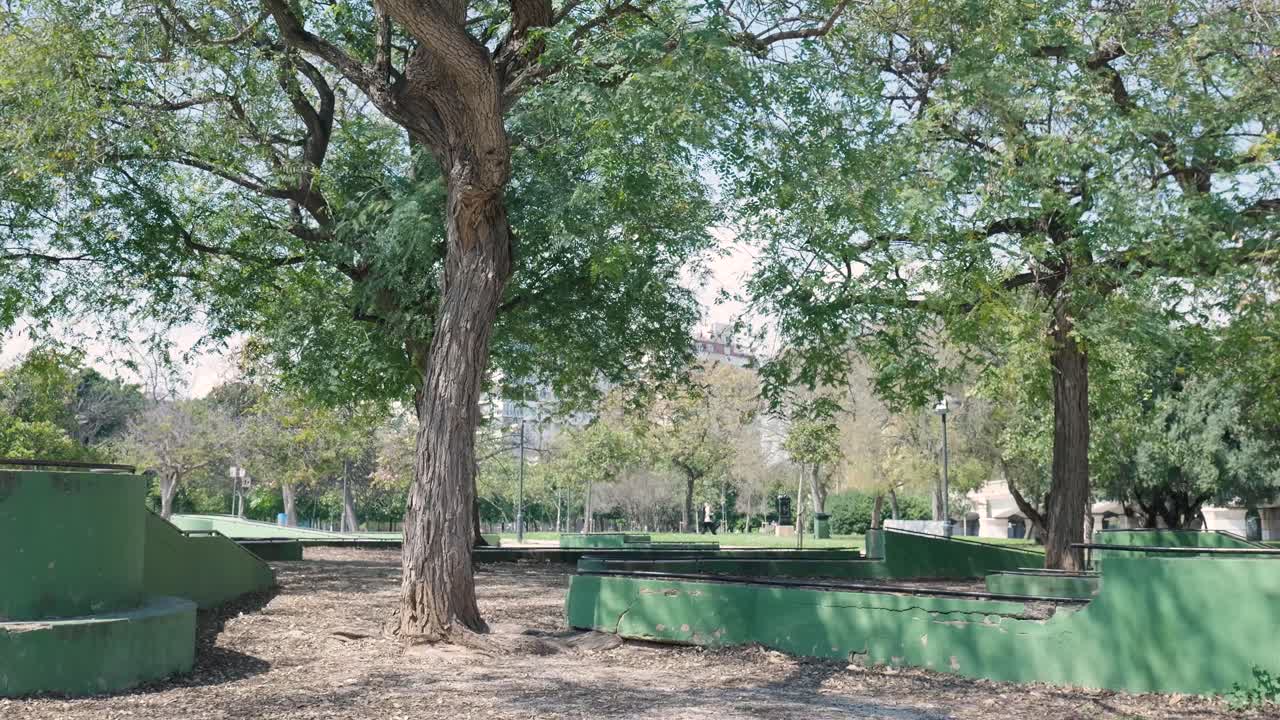 Empty park scene with green structures and trees
