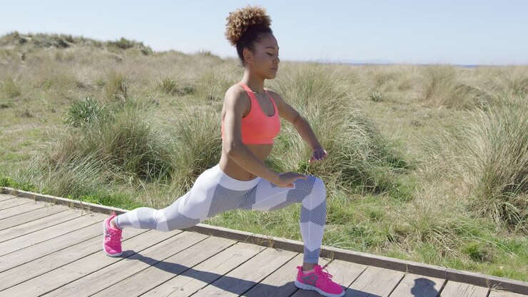 Sporty athletic woman stretching a leg