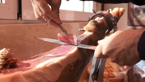iberian ham cut with knife for a man