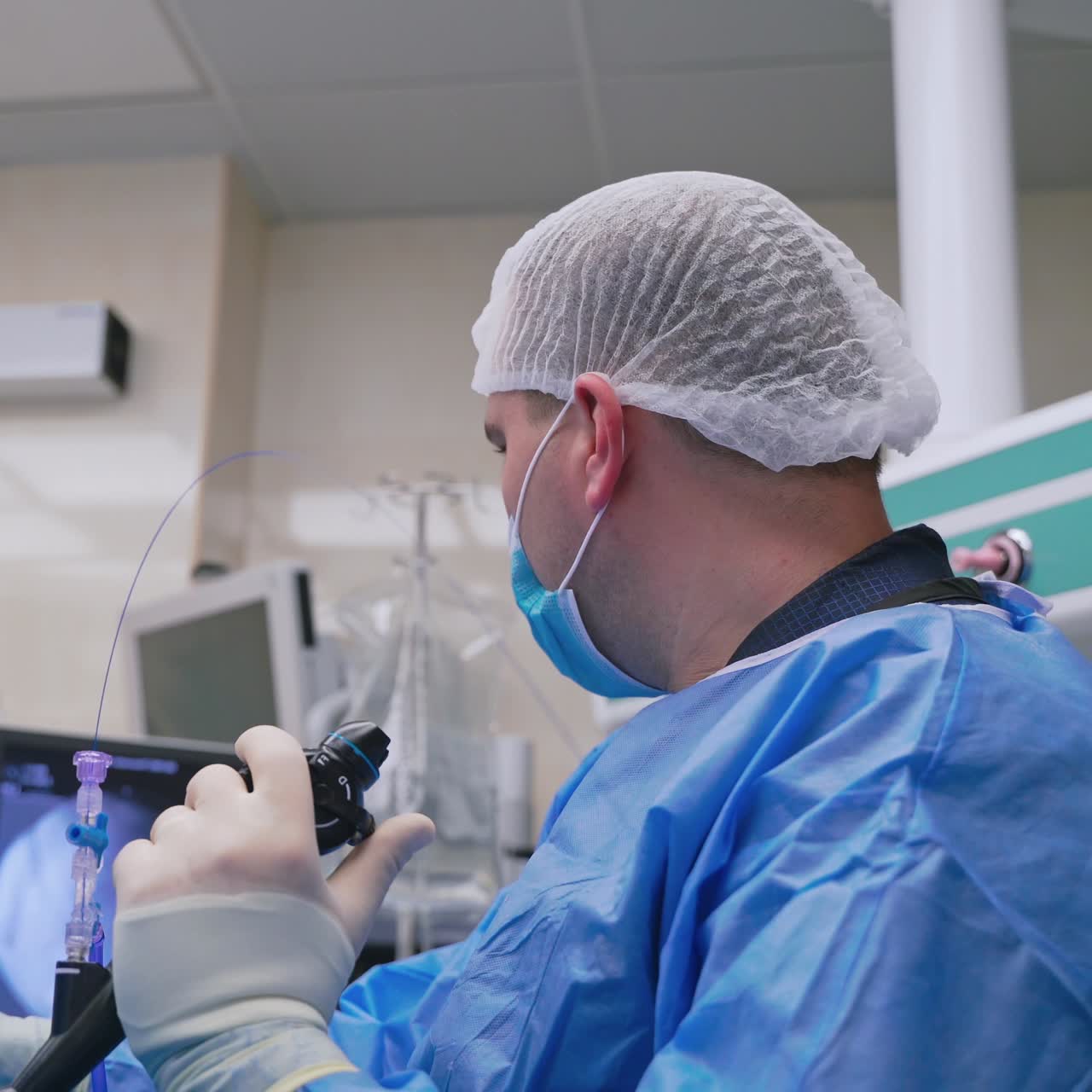 Group of doctors perform an operation to a patient. Surgeons in medical uniform and masks working in the operating room.